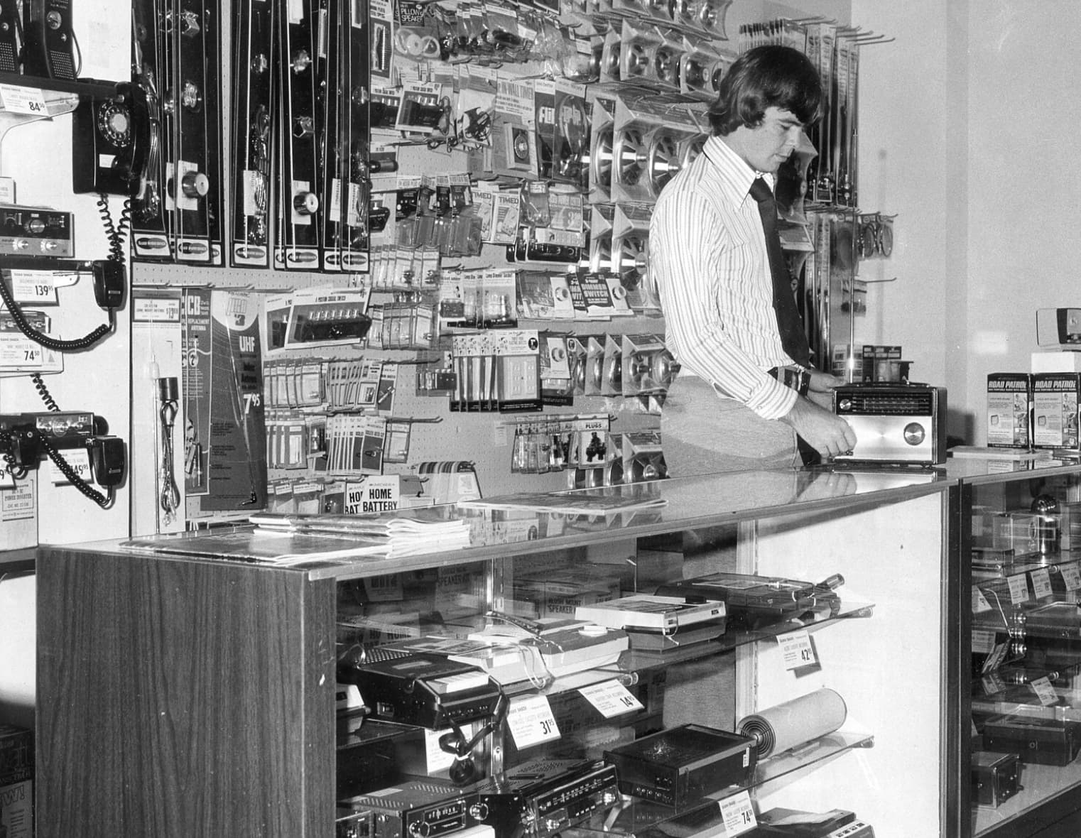 A Radio Shack Employee fiddles with the store’s namesake tech, 1972. 
